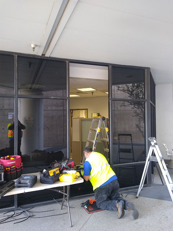 Worker installing a glass partition
