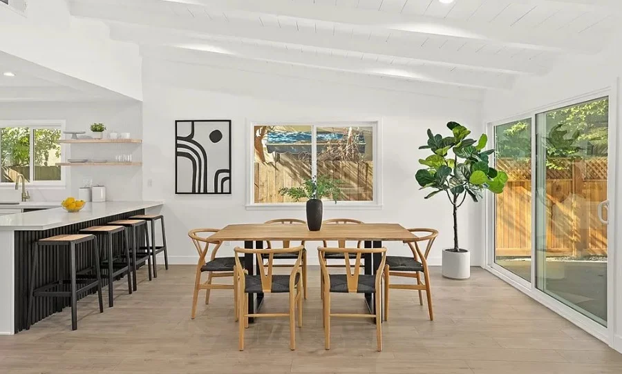Dining area beside a white kitchen