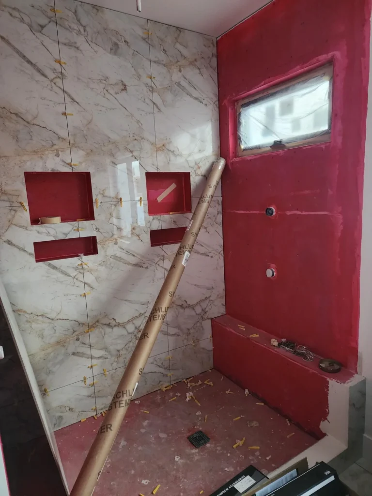 Shower renovation with red waterproofing