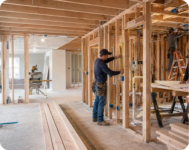 Worker building interior wall framing