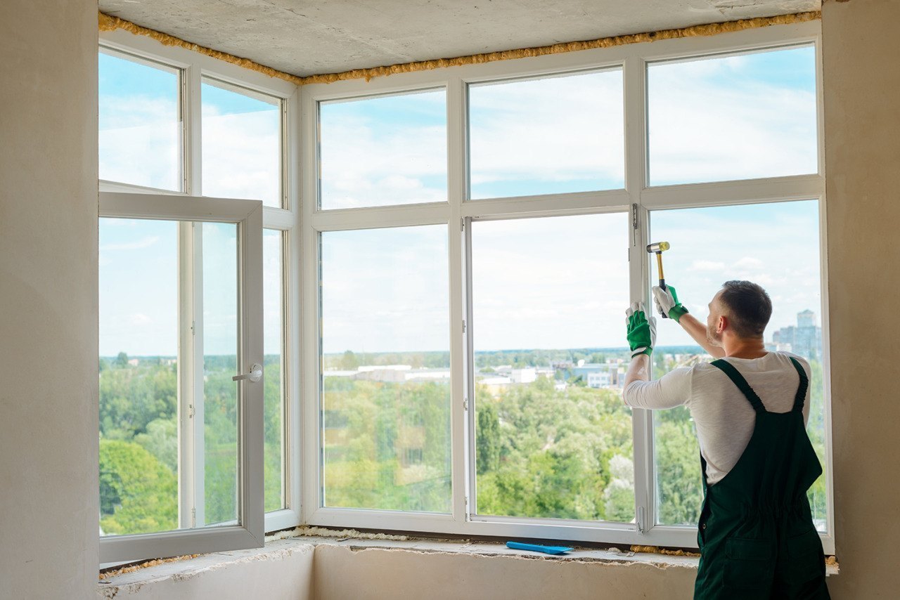 Worker fitting a window frame